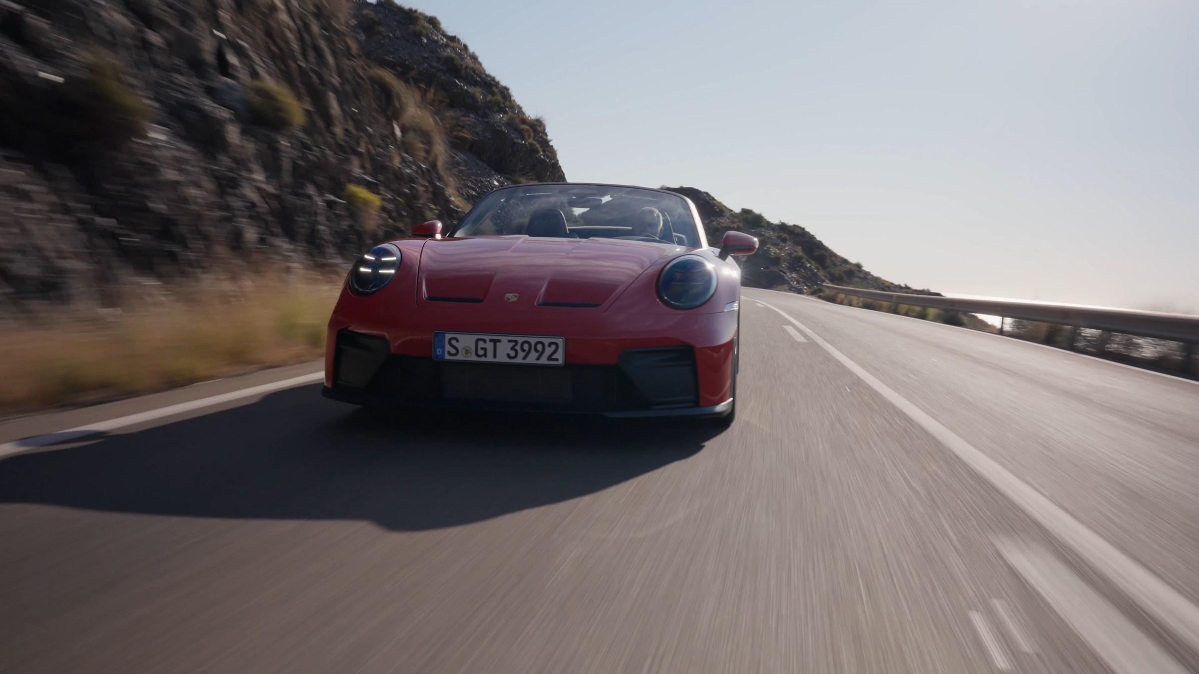 Red 911 on a coastal road