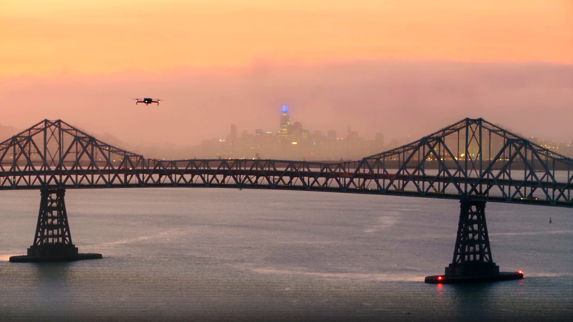 Drone above a steel bridge at dawn