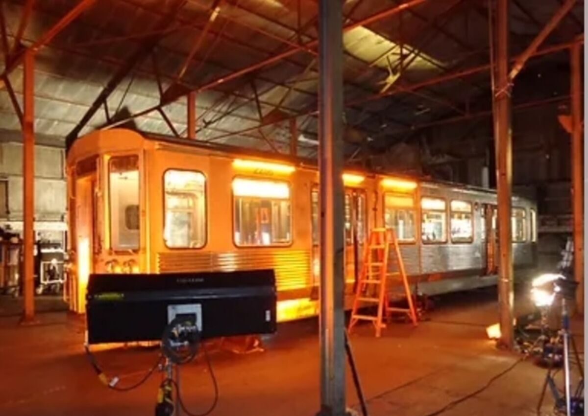 Train car glowing amber inside a warehouse stage