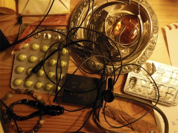 Tabletop clutter — pills, ashtray, cables