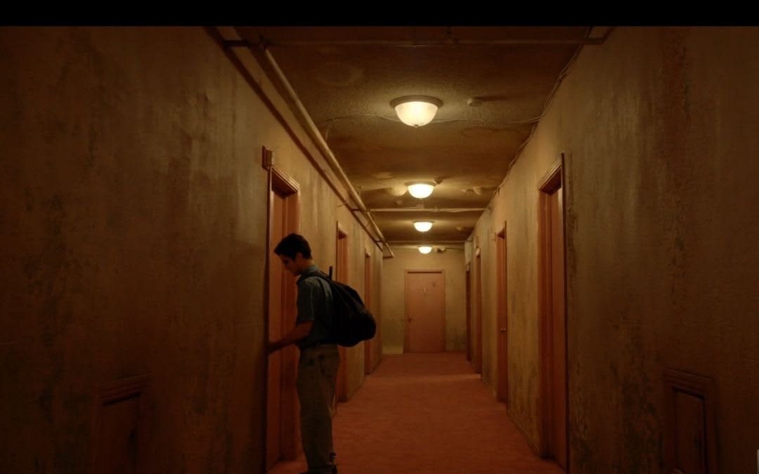 Long orange corridor of identical doors